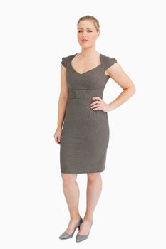 Serious woman standing against white background