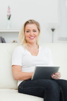 Casual woman using a notebook in a living rrom