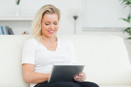 Casual woman using a tablet pc in a living room