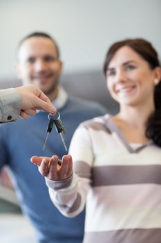 Couple receiving keys in a car shop