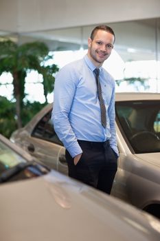 Man having hands in pockets in a dealership