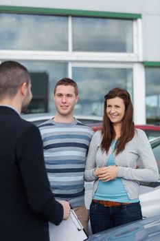 Clients talking with a dealer in a dealership