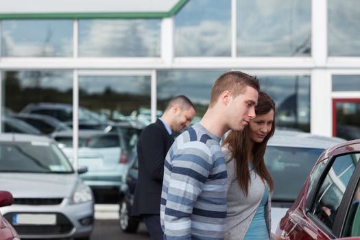 People buying a car in a dealership