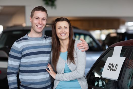 Couple purchasing a new car in a dealership