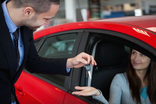 Client receiving car keys in a dealership