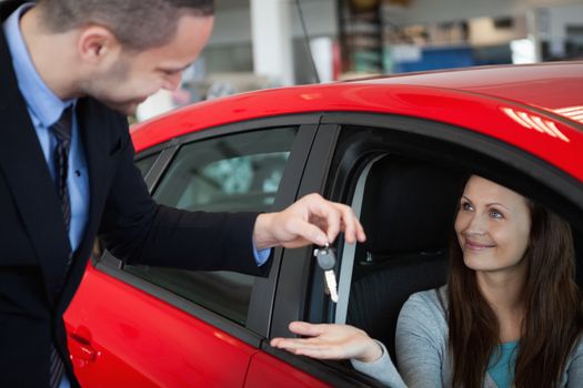 Customer receiving car keys in a dealership