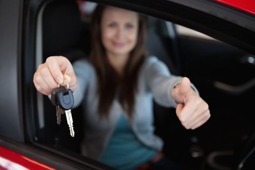 Client sitting in her car while holding car keys in her car
