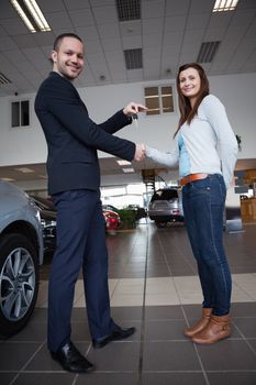 Man shaking hand with woman in a garage