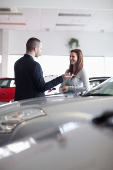 Salesman speaking with a woman in a dealership