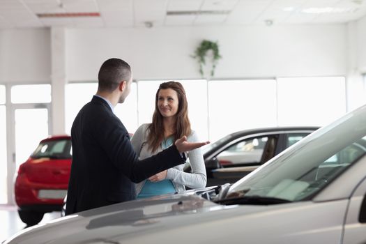 Dealer speaking to a woman in a dealership