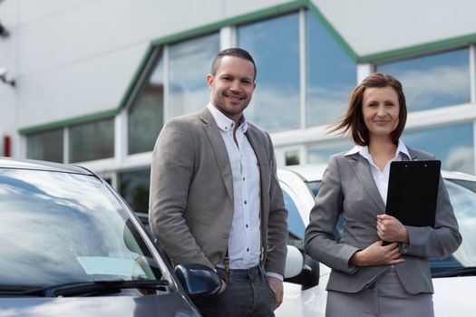 Man buying a new car in a garage