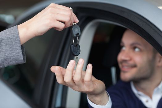 Man receiving car keys in his car