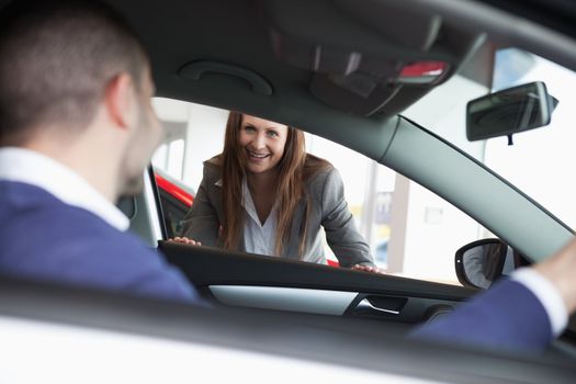 Businesswoman speaking to a client in a garage