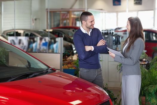 Man speaking to a businesswoman in a garage