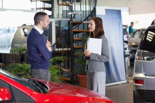 Man speaking with a businesswoman in a dealership