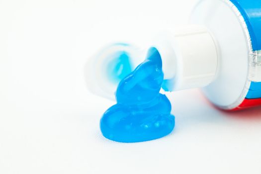 Close up of toothpaste outgoing of a toothpaste tube against white background