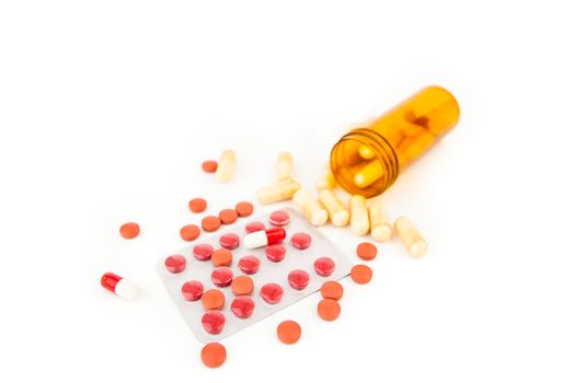 Bottle of medications knocked over against white background