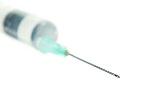 Syringe against white background