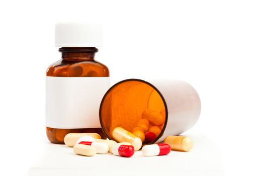 Container of medications knocked over against white background