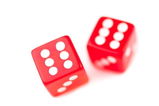 Two red dices in motion against a white background