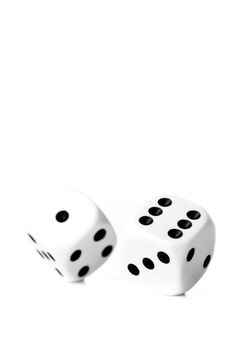 Two black and white dices in motion against a white background