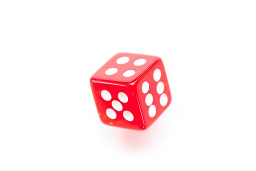 Red dice moving against a white background