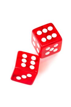 Two red dices rolling against a white background