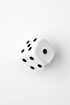 Black and white dice in motion against a white background