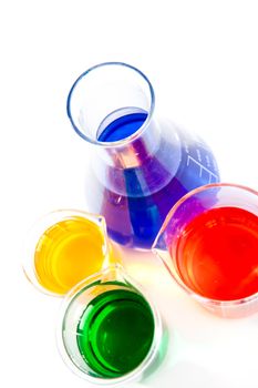 Three beakers and an erlenmeyer against a white background