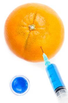 Syringe injecting blue liquid in an orange against a white background