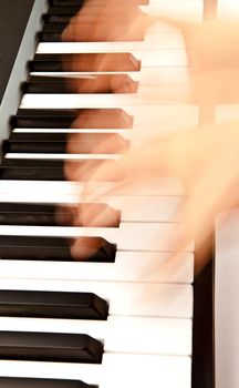 Hands playing piano in motion