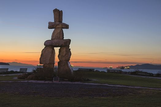 Inukshuk Stone Sculpture on Sunset Beach Alond English Bay in Vancouver BC Canada during Sunset