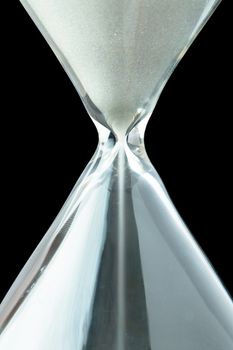 Close up of a hourglass against a black background