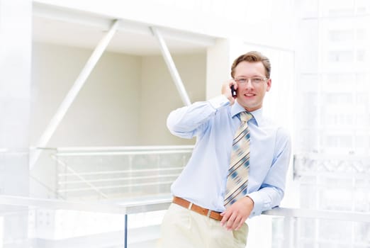 Smiling business man, talking on cell phone