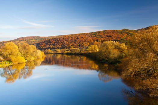 Reflection on the river in autumn at sunrise