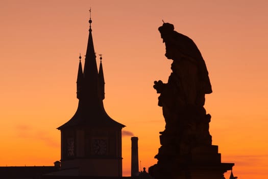 The statue and famous tower on Charles Bridge in Prague in Czech Republic