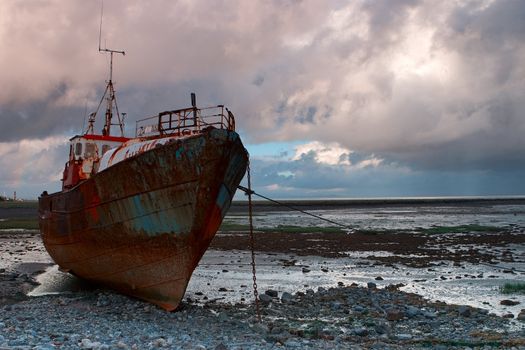 Dead fishing boat on the beach