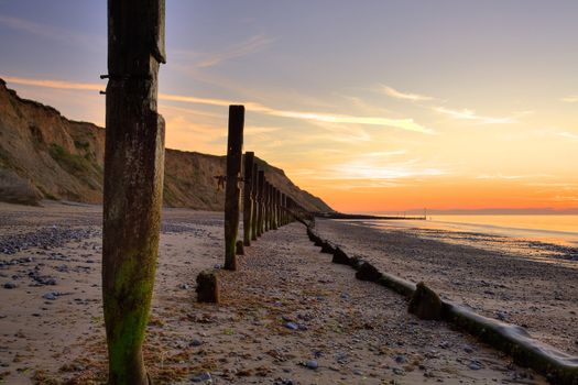 Breakwater on the beach in Norfolk in Great Britain