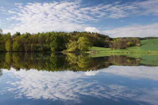 Reflection on the pond at sunset in summer