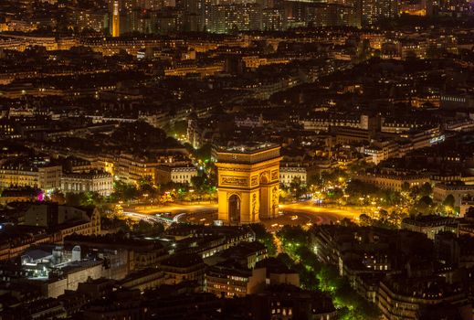 Aerial view of the Triumphal Arch area in Paris during the night.This very famous monument of Europe is located at an intersection of 12 roads in the big city.