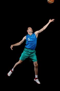 Male basketball player jumping and practicing with a ball