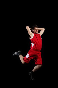 Male basketball player jumping and practicing with a ball