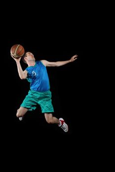 Male basketball player jumping and practicing with a ball