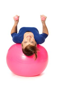 instructor showing exercises using ball and dumbbells at gym to people