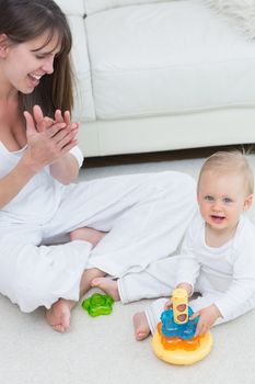 Baby sitting on the floor while playing in living room