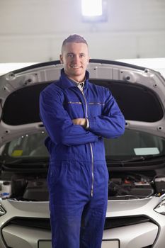 Mechanic with arms crossed in a garage