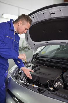 Mechanic showing an engine in a garage