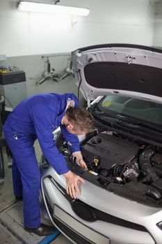 Mechanic repairing a car in a garage