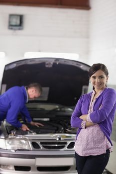 Client looking at camera with arms crossed in a garage