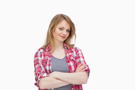 Front view of a woman smiling with arms crossed against a white background
